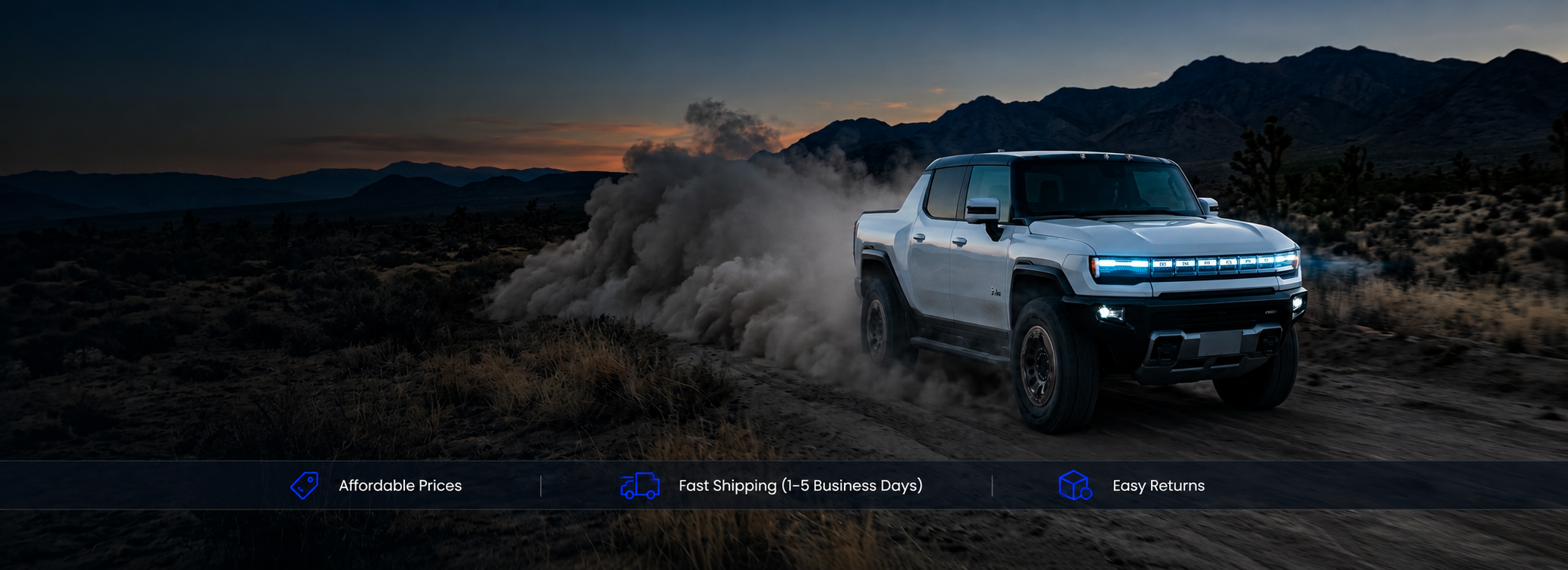 White pickup truck driving through a desert landscape.