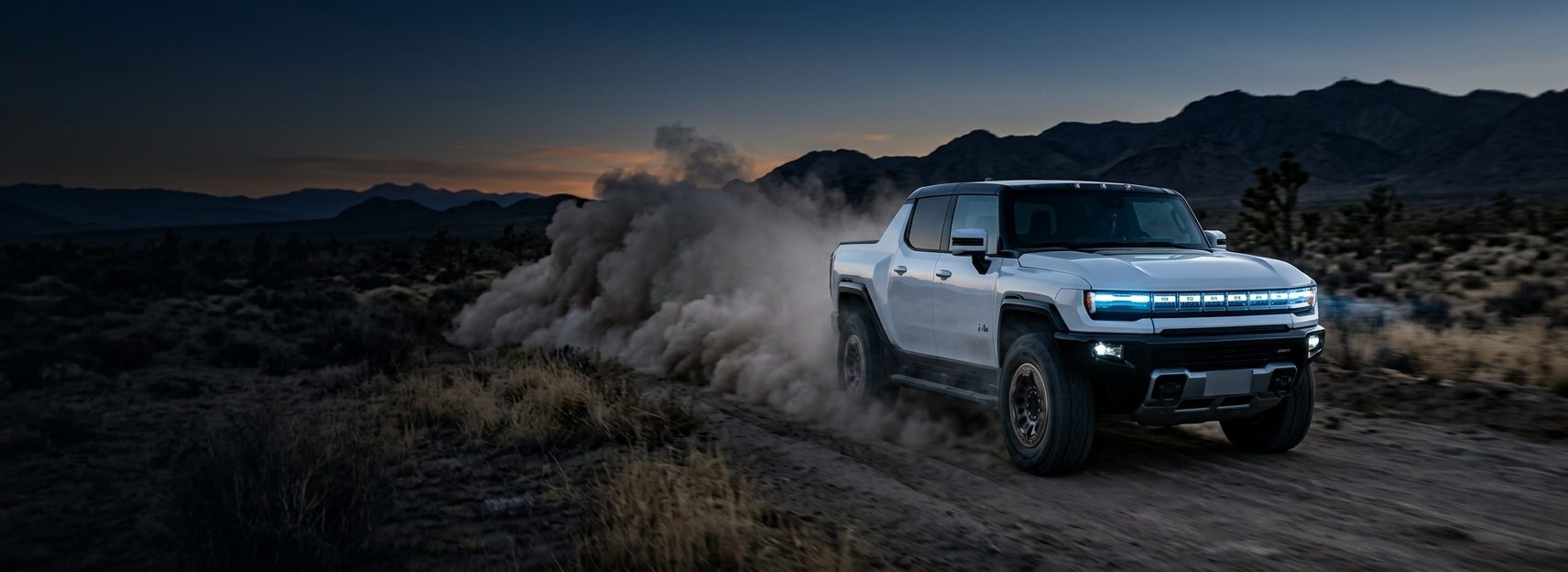 Local Auto Part hero banner featuring a premium electric pickup truck driving off-road at dusk